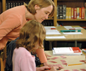Teacher helping student with syllable cards
